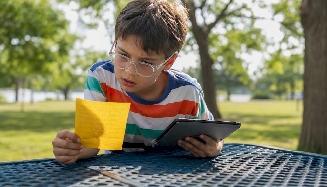 Young boy confused with password notes in library