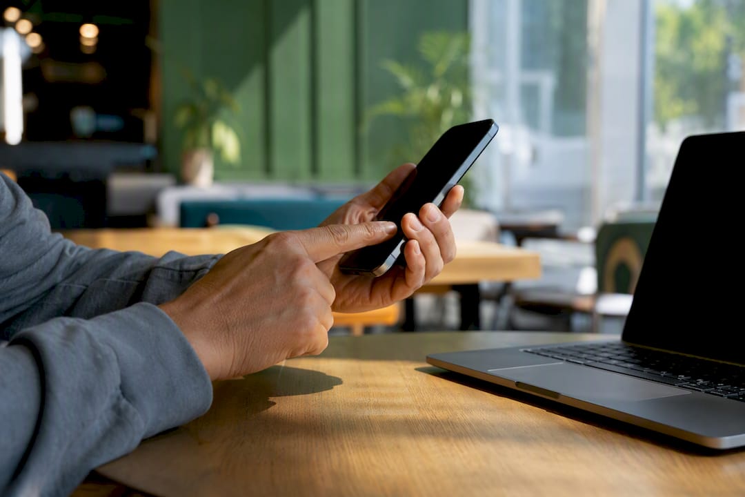 Hands carefully checking captive portal URL on phone