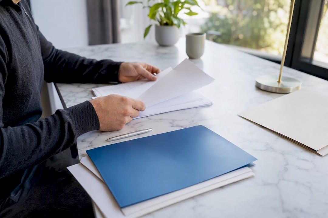 Hands preparing legal takedown paperwork